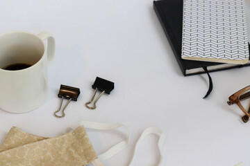 Flat lay of personal items for work and time management with face fabric mask against the covid-19,...