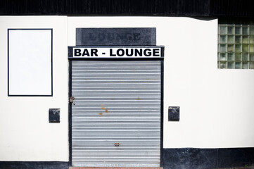 Bar lounge with blank signs and closed shutter door