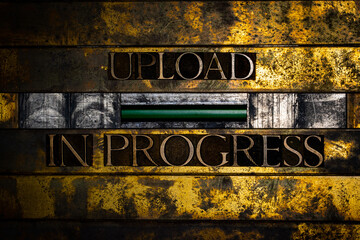 Upload In Progress text message with green confirmation LED on vintage textured grunge copper and gold background