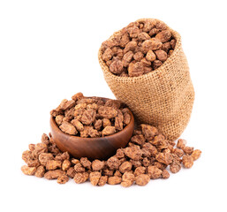 Tigernuts isolated on white background. Chufa nuts or tiger nuts in wooden bowl and small burlap sack.