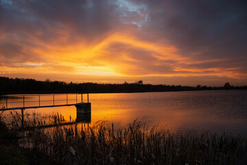 Colorful evening clouds during sunset over the lake