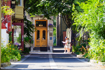 Romantic backstreet, side street or alley in historic old town of Quebec City, Canada with French...