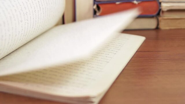 Scrolling through the pages of a thick notebook with handwritten English text