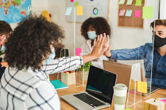 Multiracial Staff At Work In Coworking Office - Young People Wearing Surgical Mask For Coronavirus - Work Places With Safety Measures