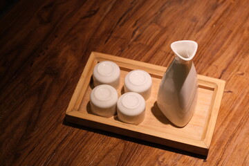 high angle view of traditional Japanese wine bottle and cups