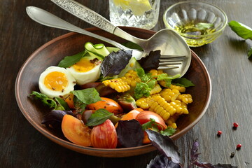 Corn salad with vegetables and boiled egg, copy space
