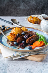 Venison sausages with blueberry gravy