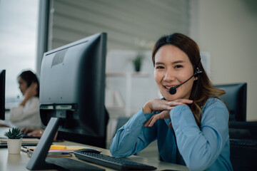 Young happy female call center are smiling and looking at camera.