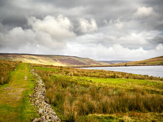 A country track winds its way through moorland around Scar House reservoir.  Nidderdale. Yorkshire Dales