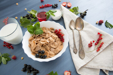 Breakfast Cereal, Table setting. Healthy tasty breakfast multigrain wholewheat healthy cereals with strawberries, raspberries, black currants and red currants