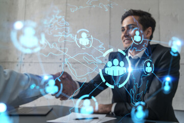 Two businessman shaking hands and social network hologram. Double exposure. Concept of international people connection. Handshake.