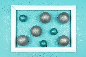 Frame with Christmas blue and silver baubles. Festive greeting card for new year.