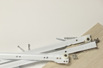Roller guides for installation during furniture assembly, background.