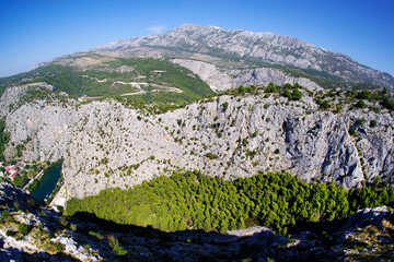 Naklejka premium Dalmatian coastline mountains near Omis. Sunny day with blue sky