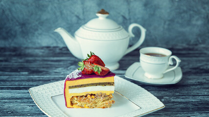 Appetizing a piece of mousse cake decorated with strawberries, blueberries and a pomegranate sectional view with poppy seed filling on gray