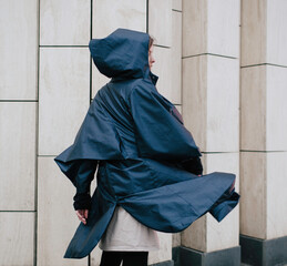 Girl on the street in a raincoat, autumn weather