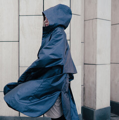Girl on the street in a raincoat, autumn weather