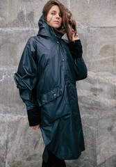Girl on the street in a raincoat, autumn weather