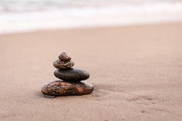 Fototapeta na wymiar Stacking stones by the sea in autumn