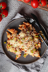 Pasta with cherry tomatoes, peas and Parmesan cheese. Homemade Italian pasta with tomatoes and sauce