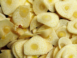 Garlic slices texture background, top view shot