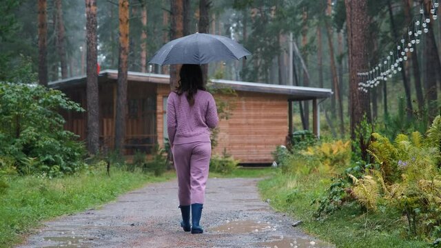 Smiling Female with Umbrella Enjoying Walking in the Rain in Nature. Slow Motion. Autumn Season, Harmony with Nature and People concept