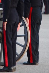 two soldiers standing at attention in historical military uniforms.  