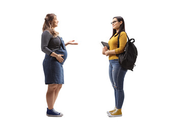 Full length profile shot of a pregnant woman talking to a female student