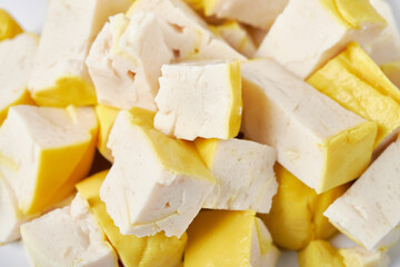 close up chopped yellow soft tofu background