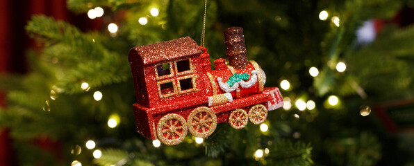 red toy locomotive hanging on the Christmas tree
