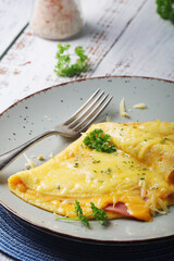 Omelette with ham and cheese on the plate