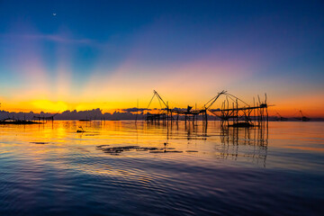 Chinese fish nets during sunrise in Phatthalung province, Thailand