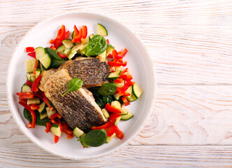 Fried dorado fish fillet and salad