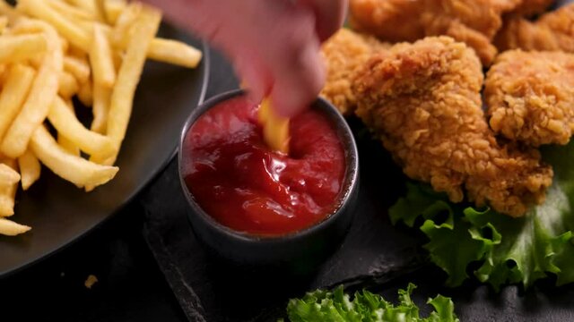 Junk food. French fries and kentucky fried chicken wings. Chips and fried chicken with tomato sauce