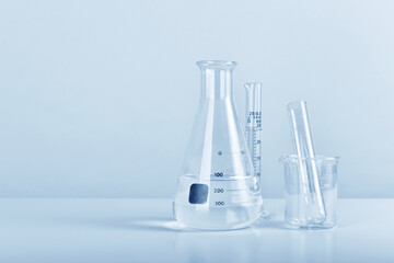 Group of scientific laboratory glassware with clear liquid solution, Science research and...