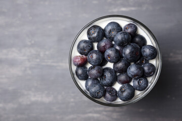 Healthy dessert. Glass of muesli, yogurt and blueberries. Top view