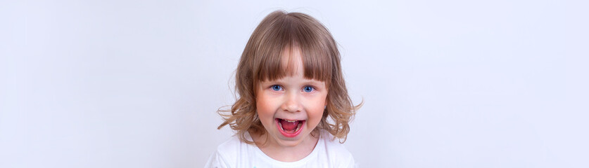 Narrow photo of a funny little cute surprised girl.