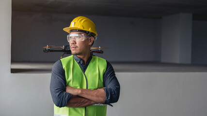 Construction worker with drone. asian contruction worker at building site.