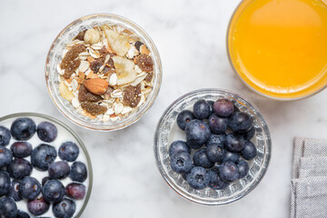Healthy breakfast with muesli, yogurt, blueberries and orange juice