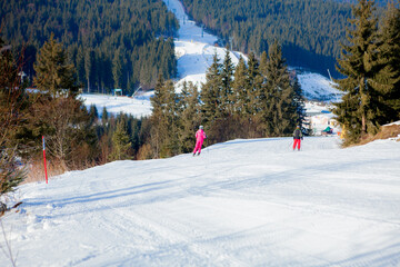 Fototapeta na wymiar Skiing people and the chair lifts of ski region in Ukraine