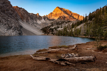 High mountain lake with a camp site in the early morning