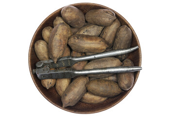 pecan nuts in a wooden bowl isolated on white background