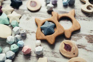 Wooden organic baby teether toy details. Flat lay set for making children's wooden toys, food grade silicone, juniper tree, beech, teethers and rattles for newborns