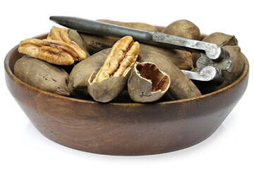 pecan nuts in a wooden bowl isolated on white background