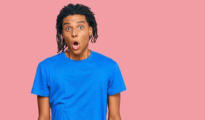 Fototapeta na wymiar Young african american man wearing casual clothes afraid and shocked with surprise expression, fear and excited face.