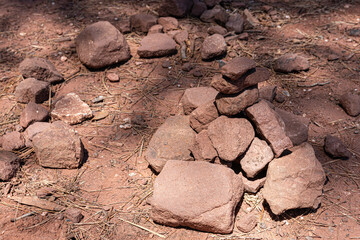 texture of a lot of large stones on the ground. reddish sand color