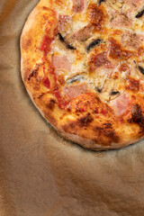 Homemade pizza with champignon mushrooms and ham