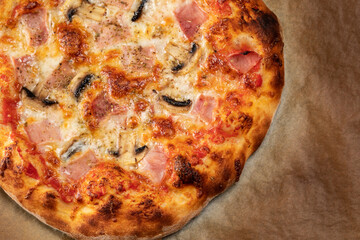 Homemade pizza with champignon mushrooms and ham