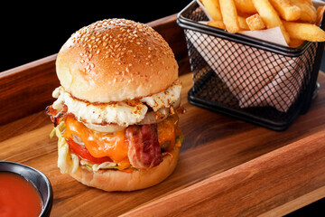 Gourmet hamburger with French fries.