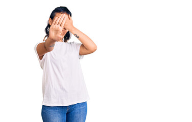 Young woman wearing casual clothes covering eyes with hands and doing stop gesture with sad and fear expression. embarrassed and negative concept.